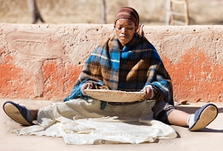 Woman Sifting Sorghum Seeds